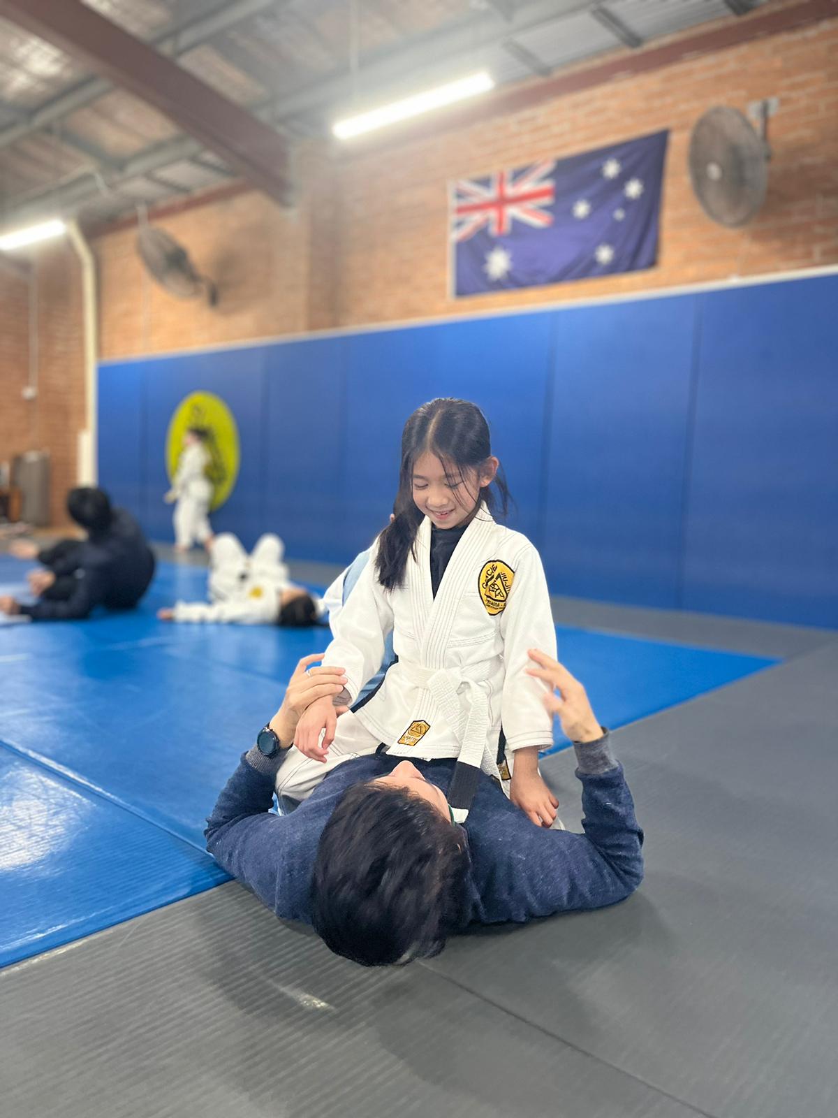 Father and daughter doing Jiu Jitsu